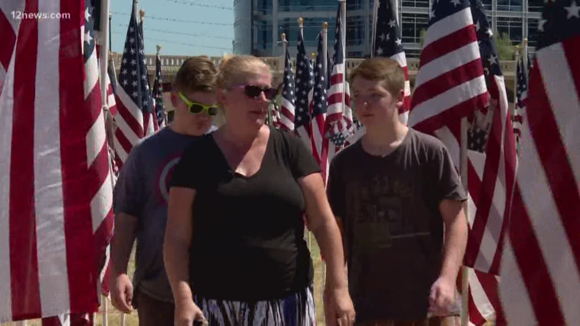 Thousands of flags were put up at Healing Field in Tempe in honor of the lives lost on 9/11. Today, a family let 12 News follow them as parents explain the significance of the day to kids who were not alive on that day.