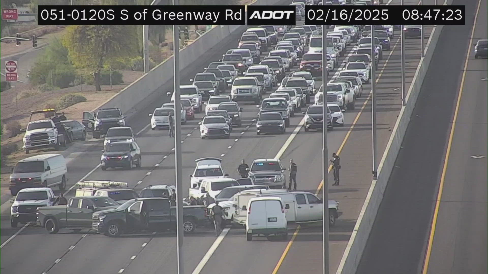 Several law enforcement vehicles can be seen at the scene from ADOT cameras.