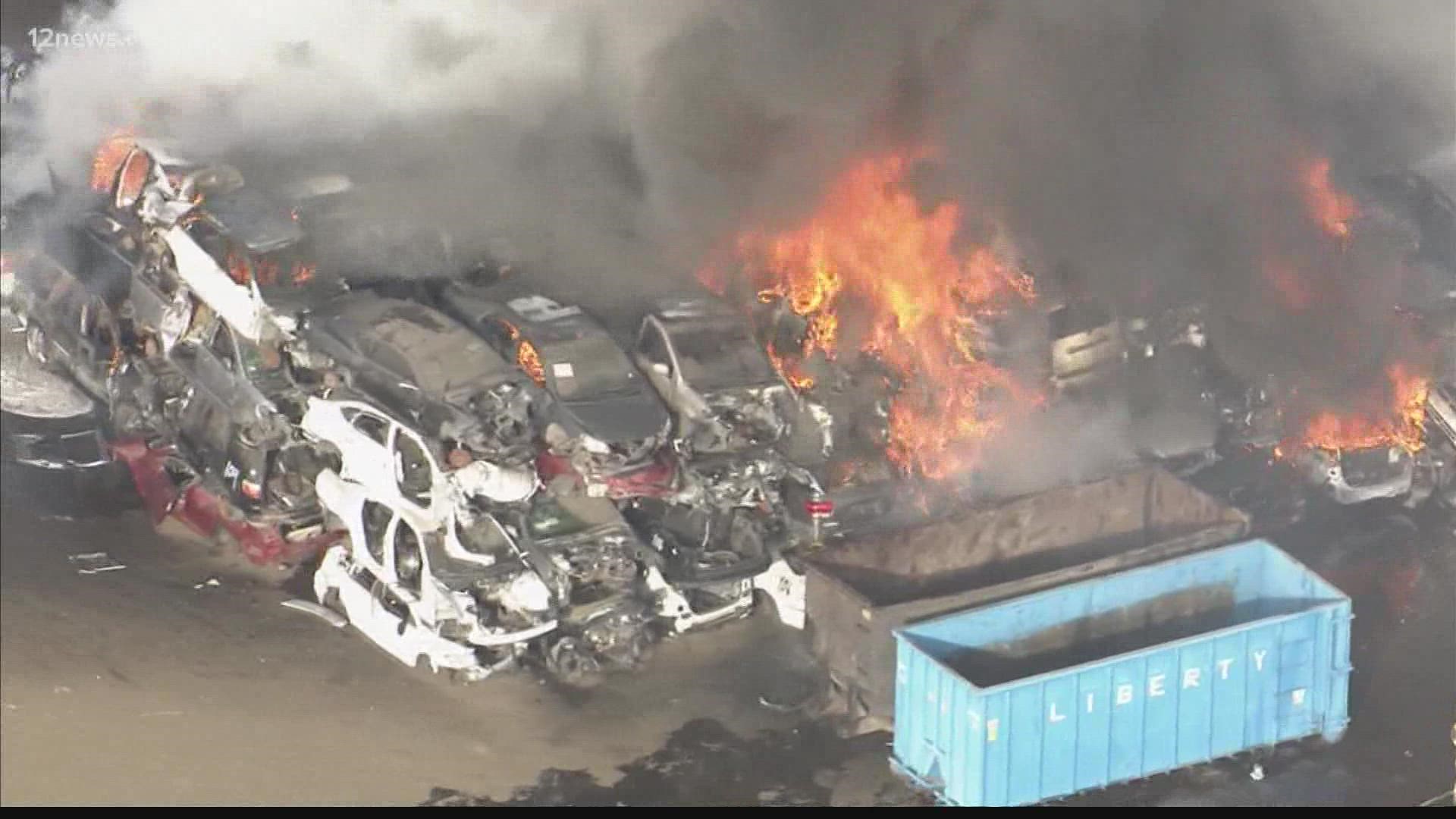 The fire is burning near 27th Avenue and Van Buren Street. Fire sent stacks of cars at the auto salvage yard up in flames.