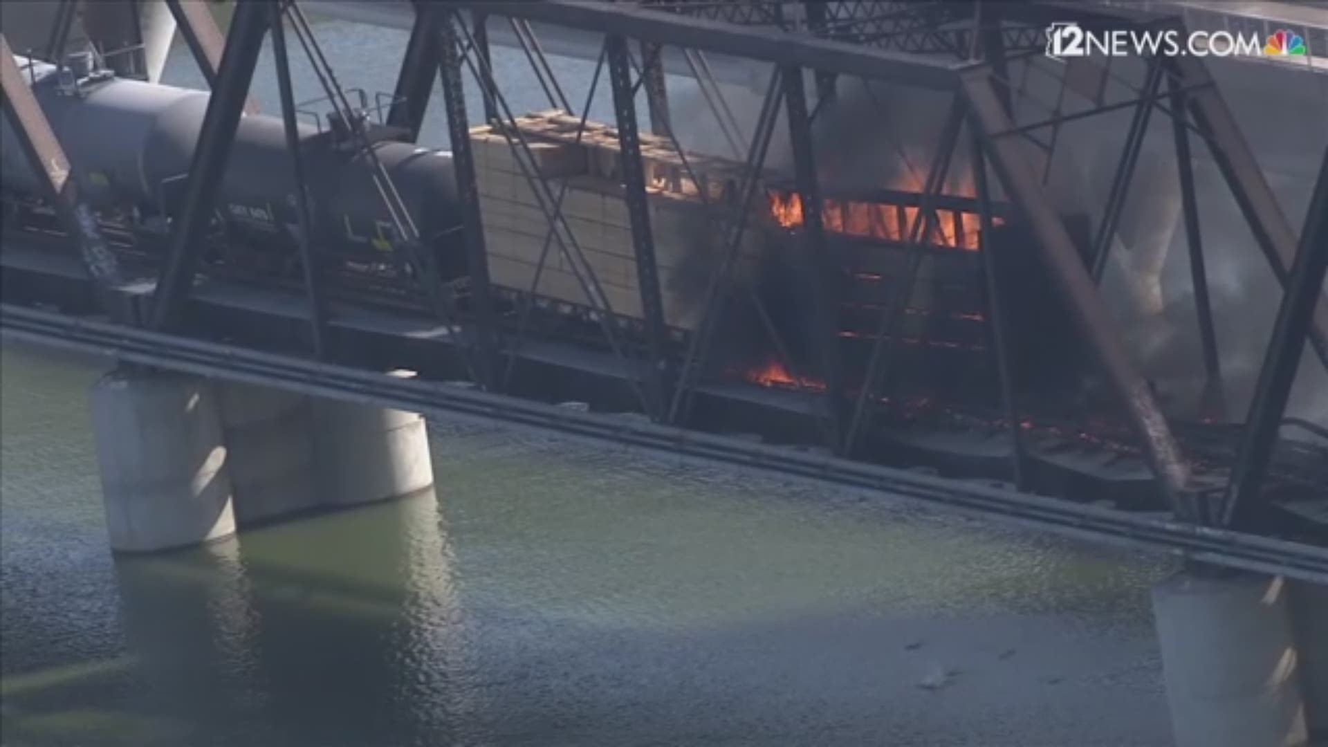 Sky 12 showed a fire burning two hours after a train derailment at Tempe Town Lake. No injuries or fatalities were reported in the incident.