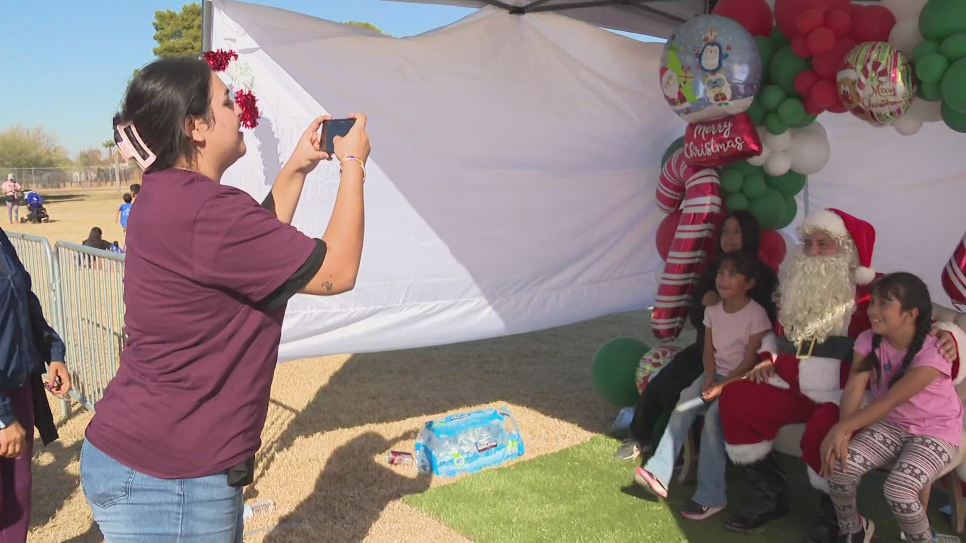 Families gathered at the South Mountain Community Center to take pictures with Santa and get some early Christmas presents, courtesy of Ángeles del Barrio.