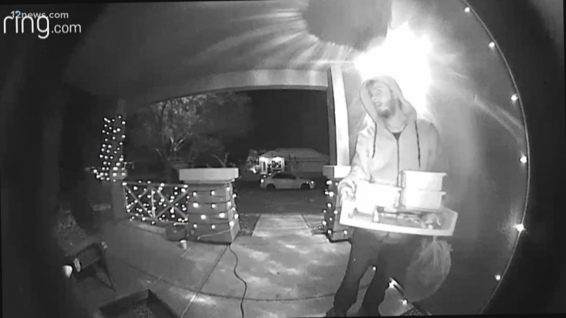 Surveillance video showed a man taking Christmas gifts from a mother's car trunk and police want him caught.