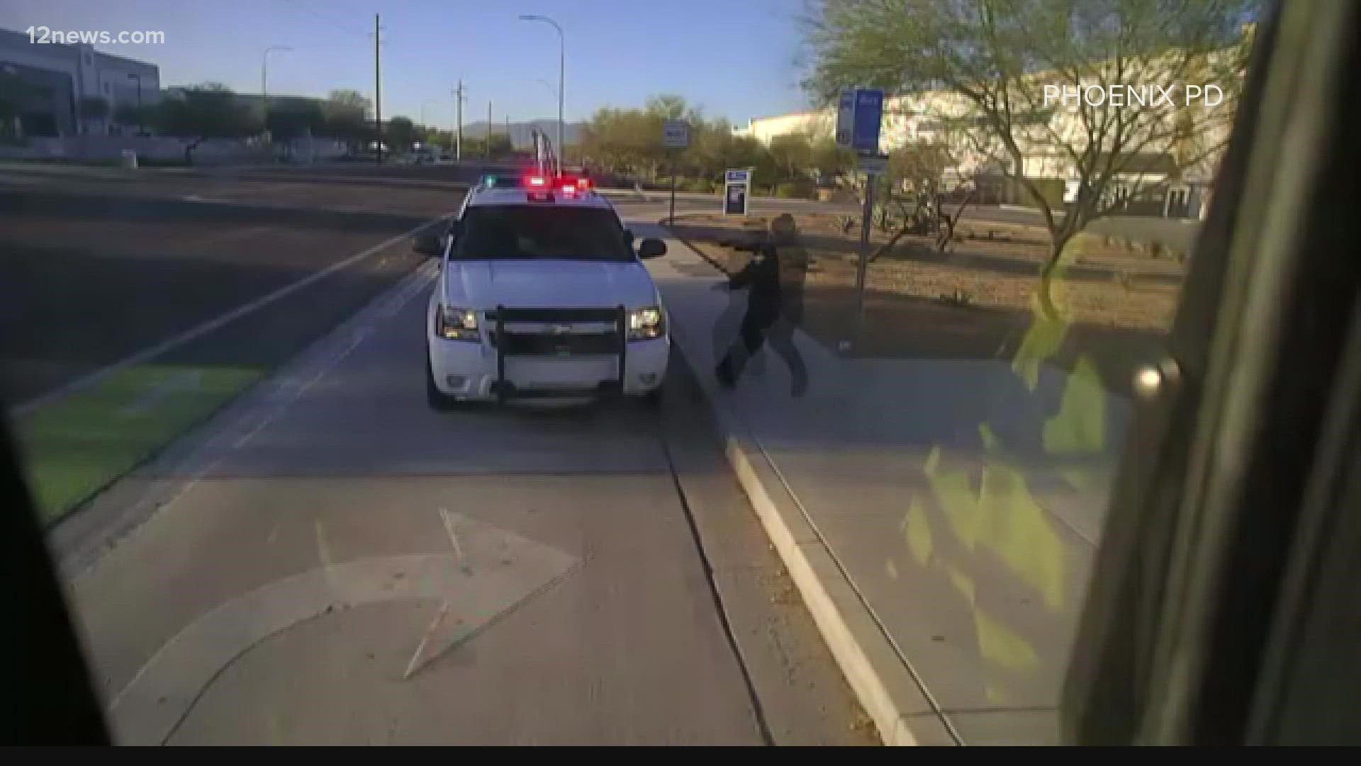 Graphic video shows the moment a Phoenix police officer shot a suspect who was taking off in his cruiser.
