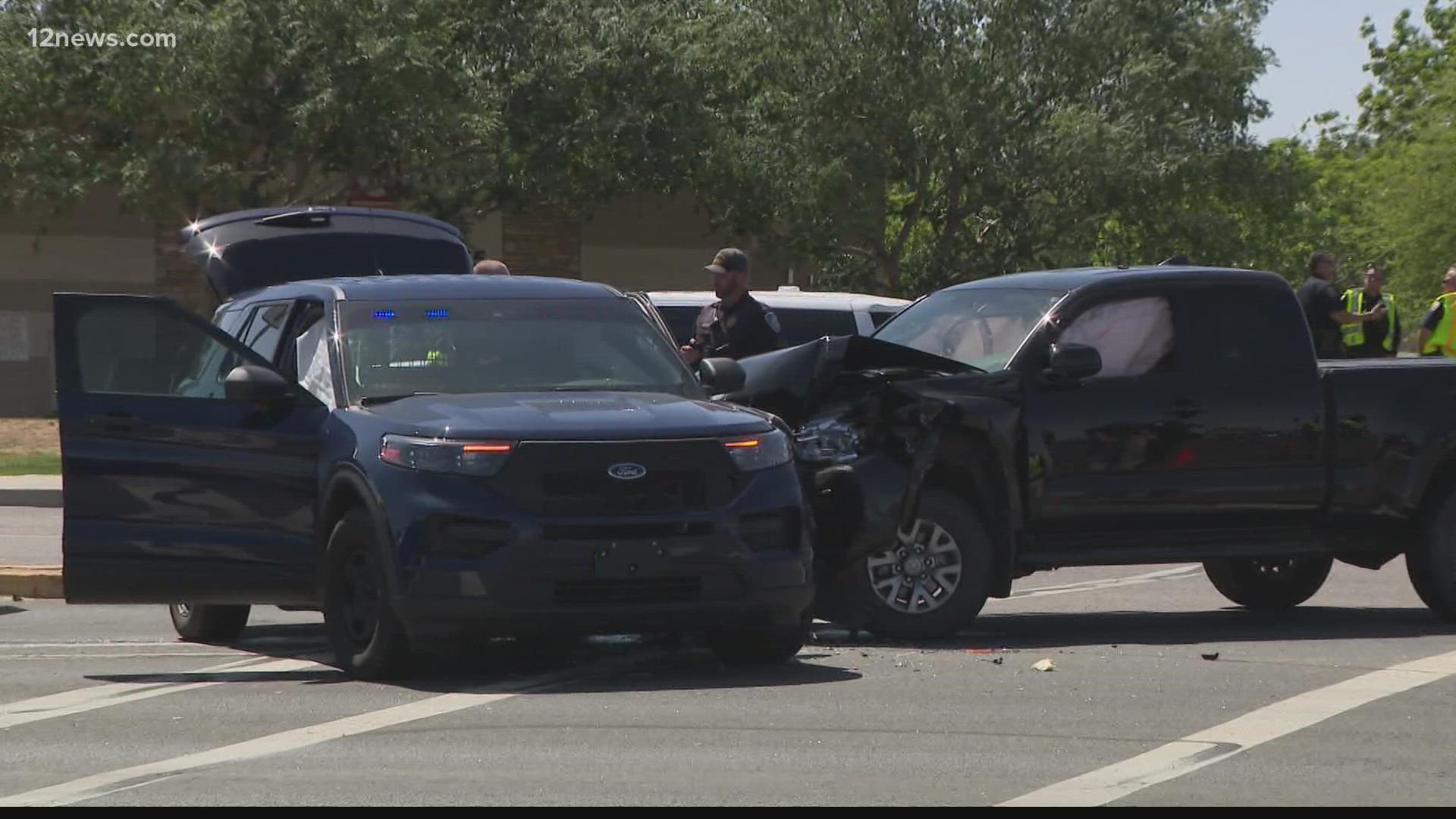 A wanted suspect has been detained after their vehicle hit a Chandler police car Monday near Gilbert and Riggs roads. There were no injuries.