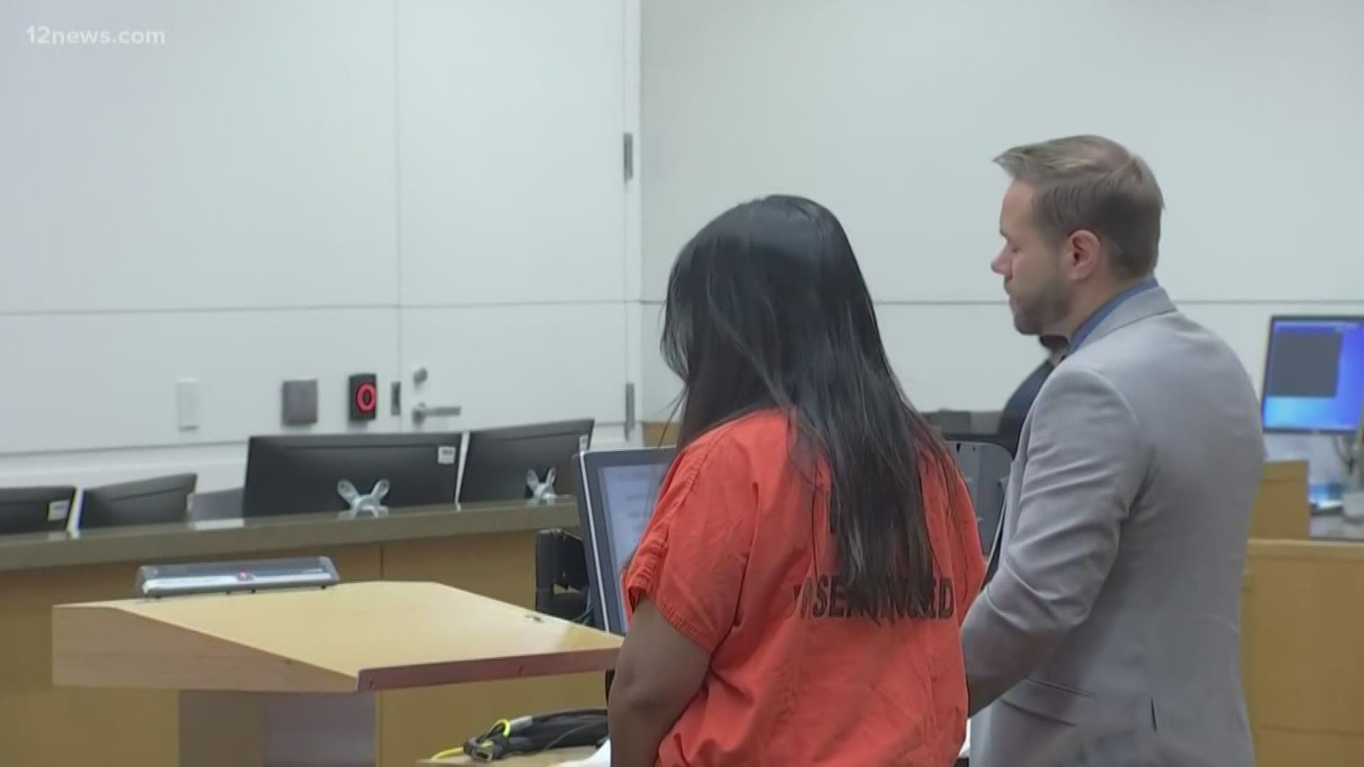 The woman who was charged along with Maricopa County Assessor Paul Petersen appeared in court Thursday. Lynwood Jenet pleaded not guilty to fraud and conspiracy.