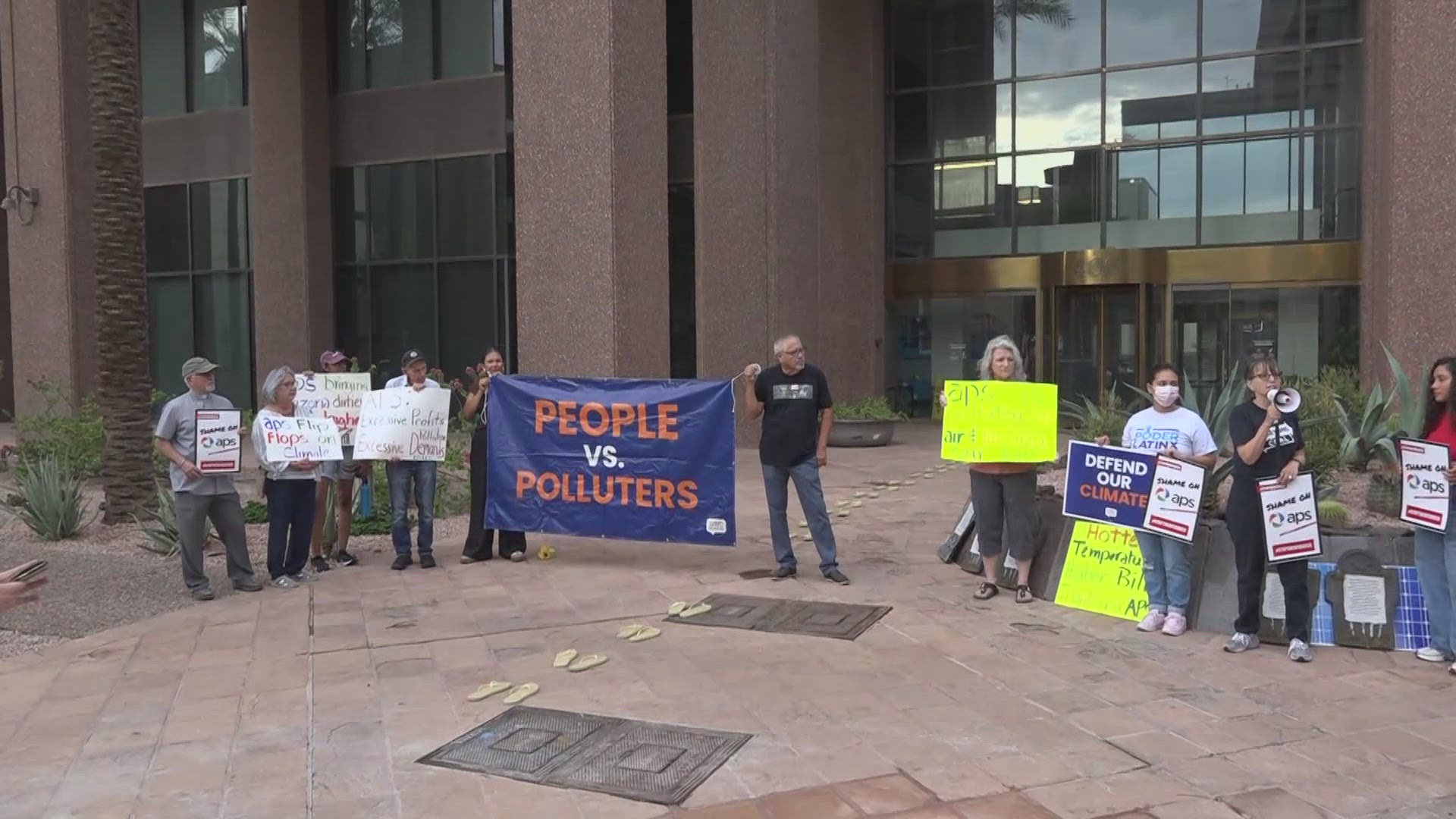 Protestors are accusing APS  of flip flopping on its green energy goals for the sake of profits.