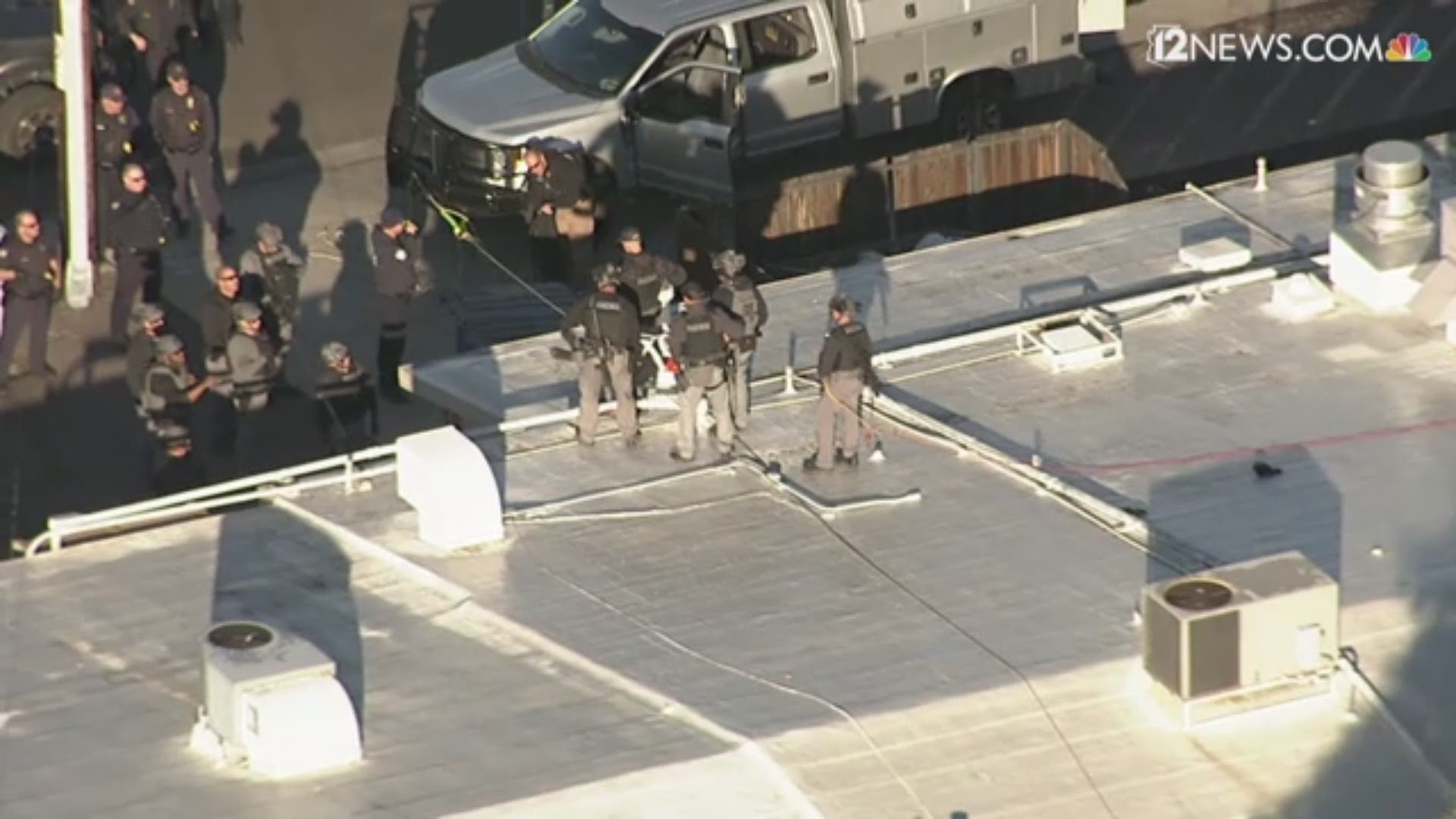 The Phoenix Police SWAT team rushed to the scene, and video shows over a dozen officers lowering the suspect from the roof of a building.