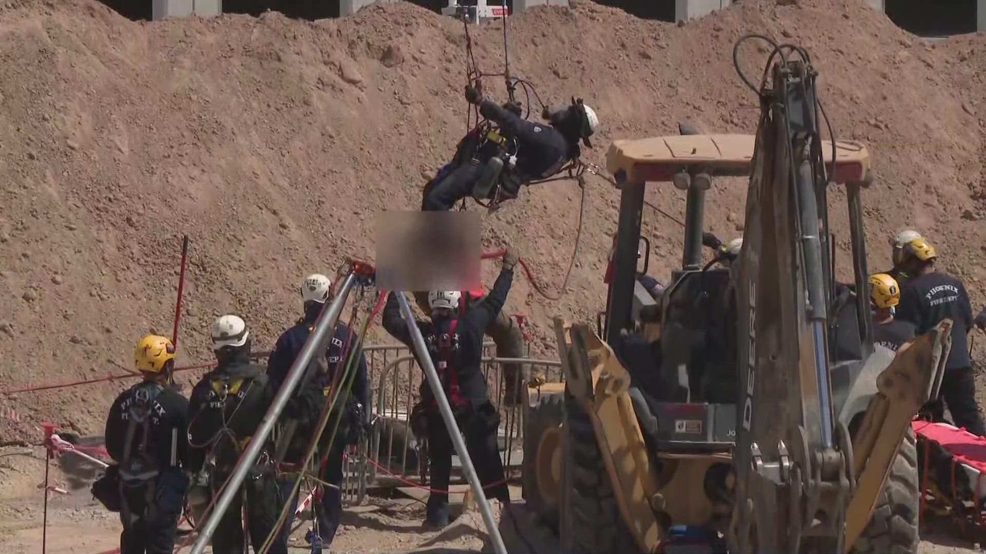 No word yet on the status of the worker stuck in the hole.