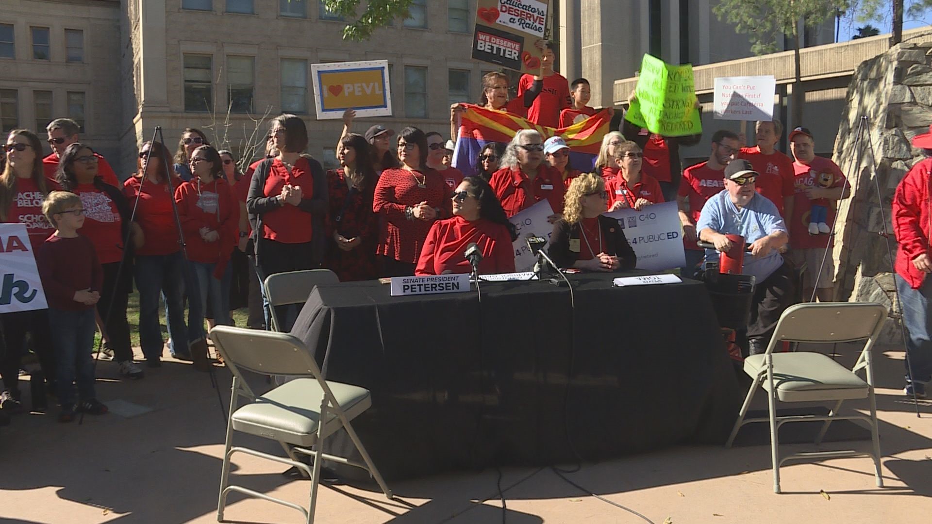 Two dozen Arizona educators gathered Monday at a metaphorical “negotiating table” outside the state capitol, asking for Republican leaders to meet with them.