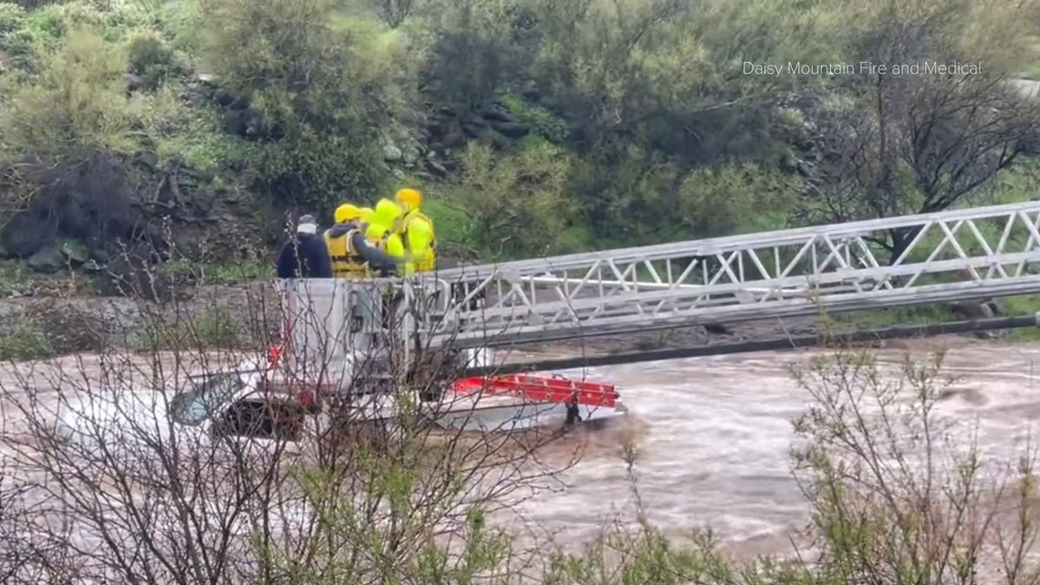 Two men rescued from roof of truck in flooded wash | 12news.com