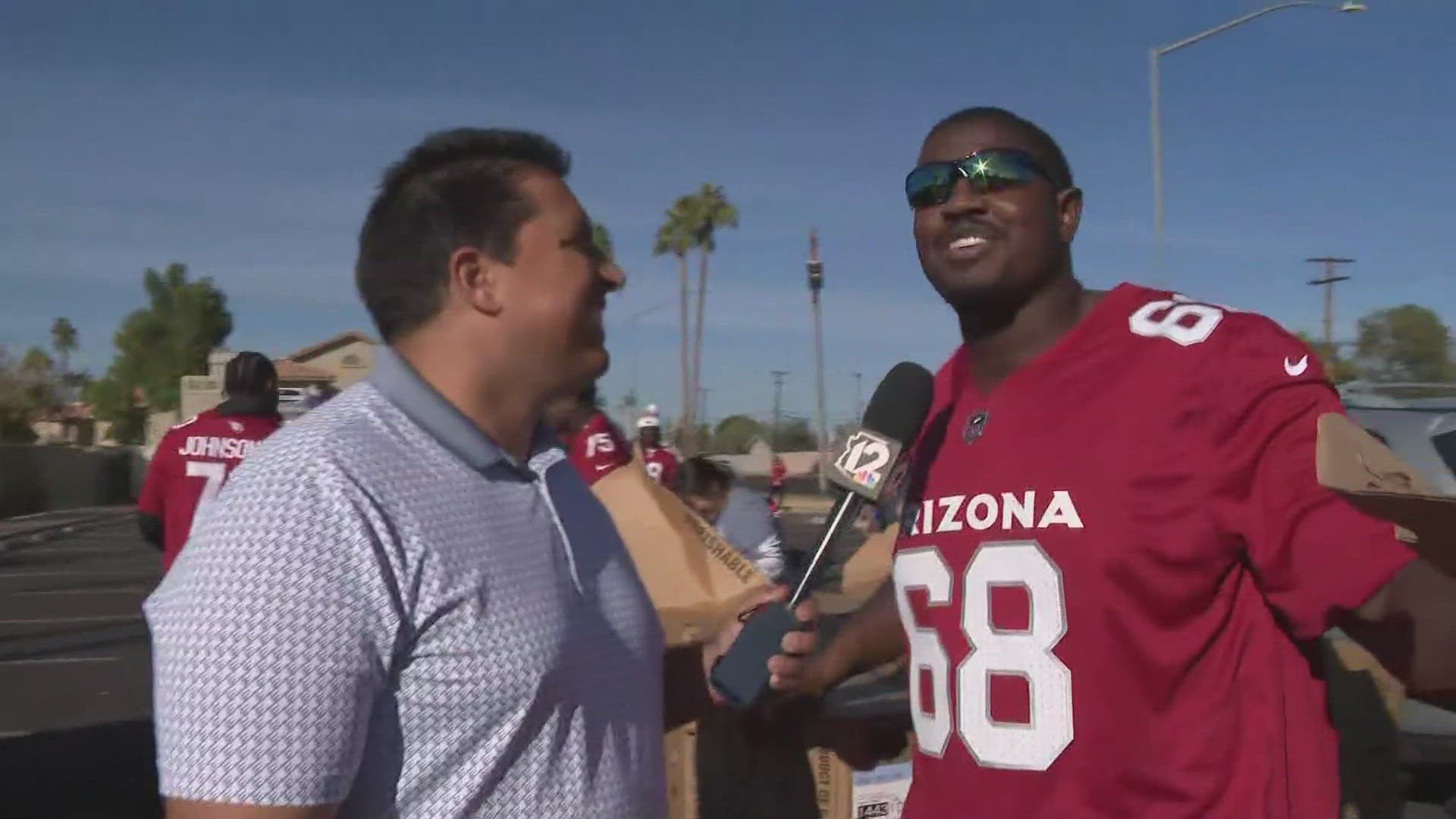 Cardinals right tackle Kelvin Beachum teaming up with left tackle Paris Johnson Jr. to pass out food for the holidays. 