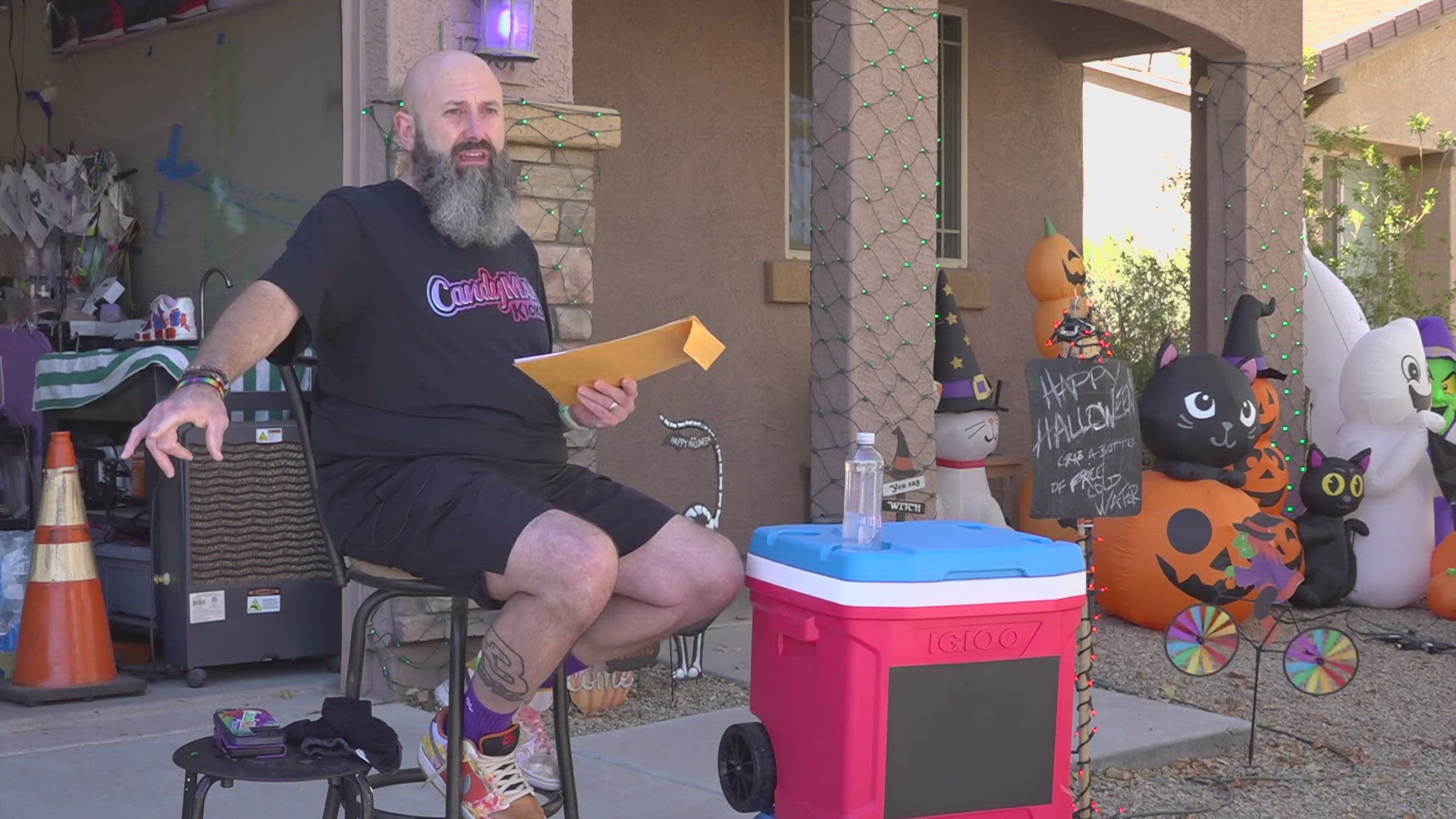 Goodyear resident David Martin has been handing out free bottles of water outside his home. His HOA wants him to be more discrete about it.