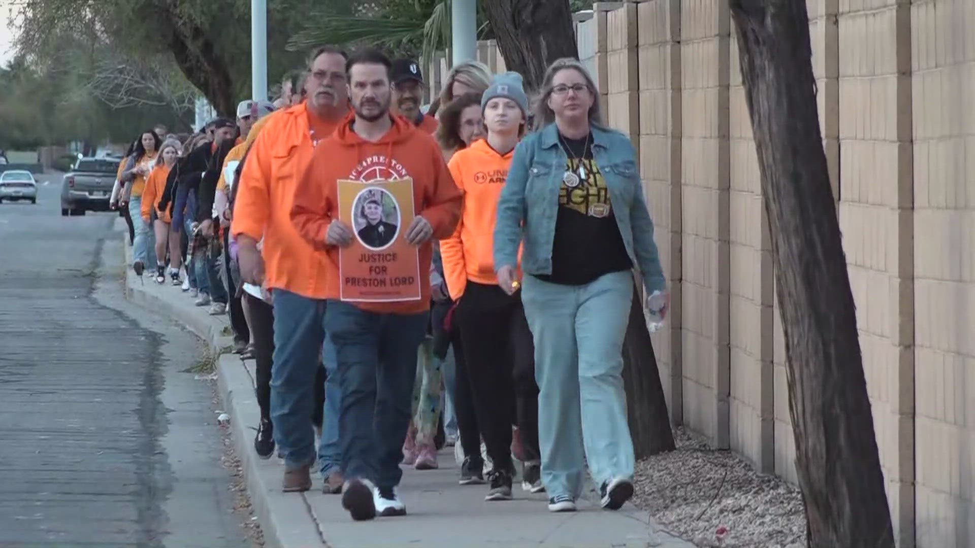 Dozens of people wearing orange walked around the Chandler Unified School District building ahead of a board meeting where they demanded change.