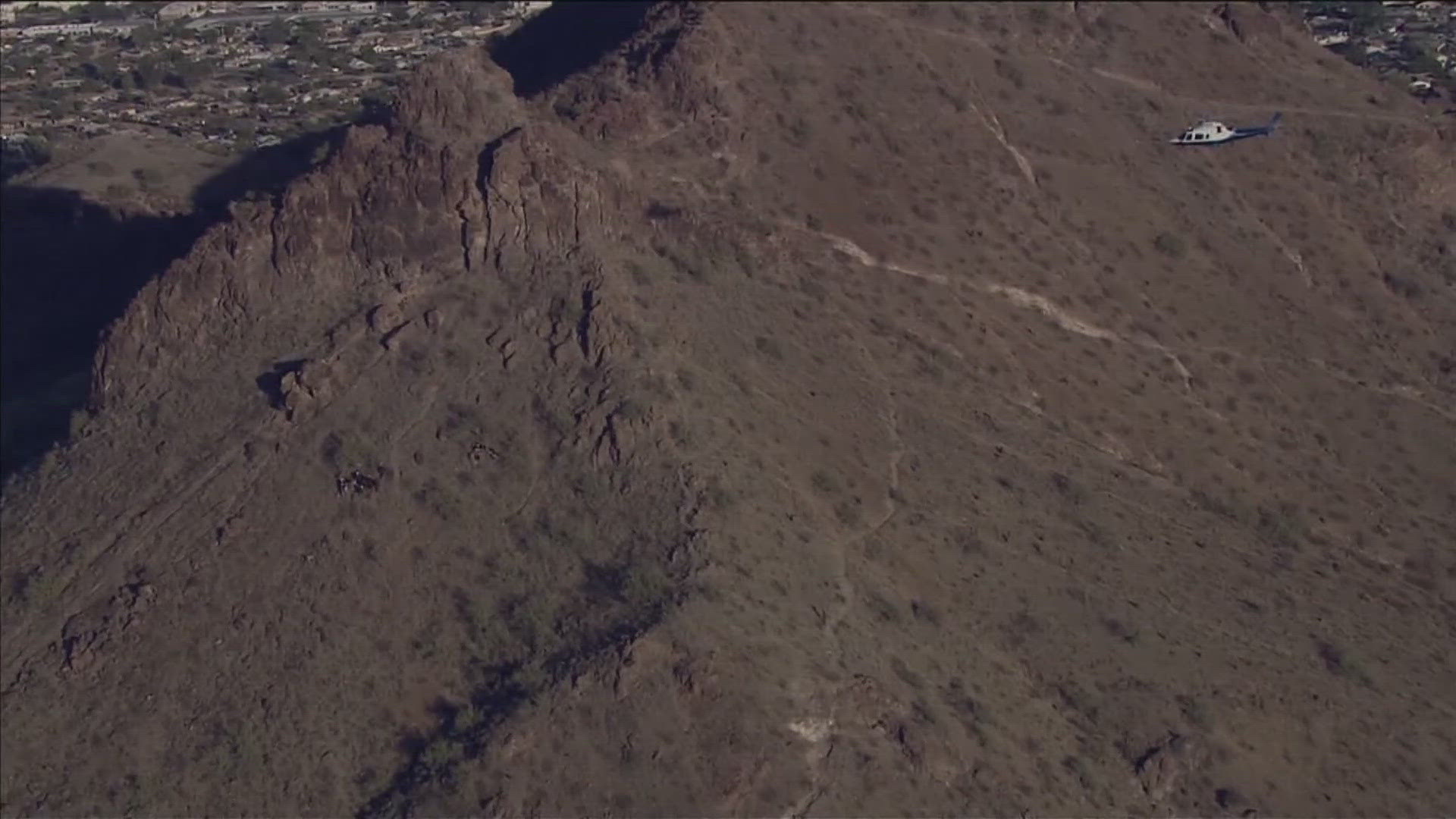 The hiker is in extremely critical condition after falling between 50 and 75 feet on the mountain, the Phoenix Fire Department said.