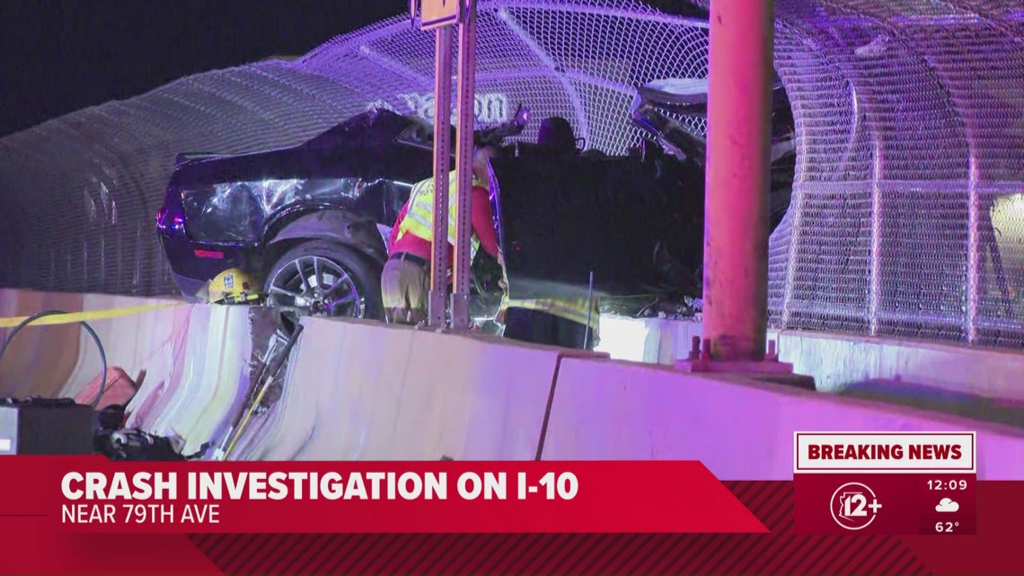 Vehicle crashes, dangles off overpass in Phoenix