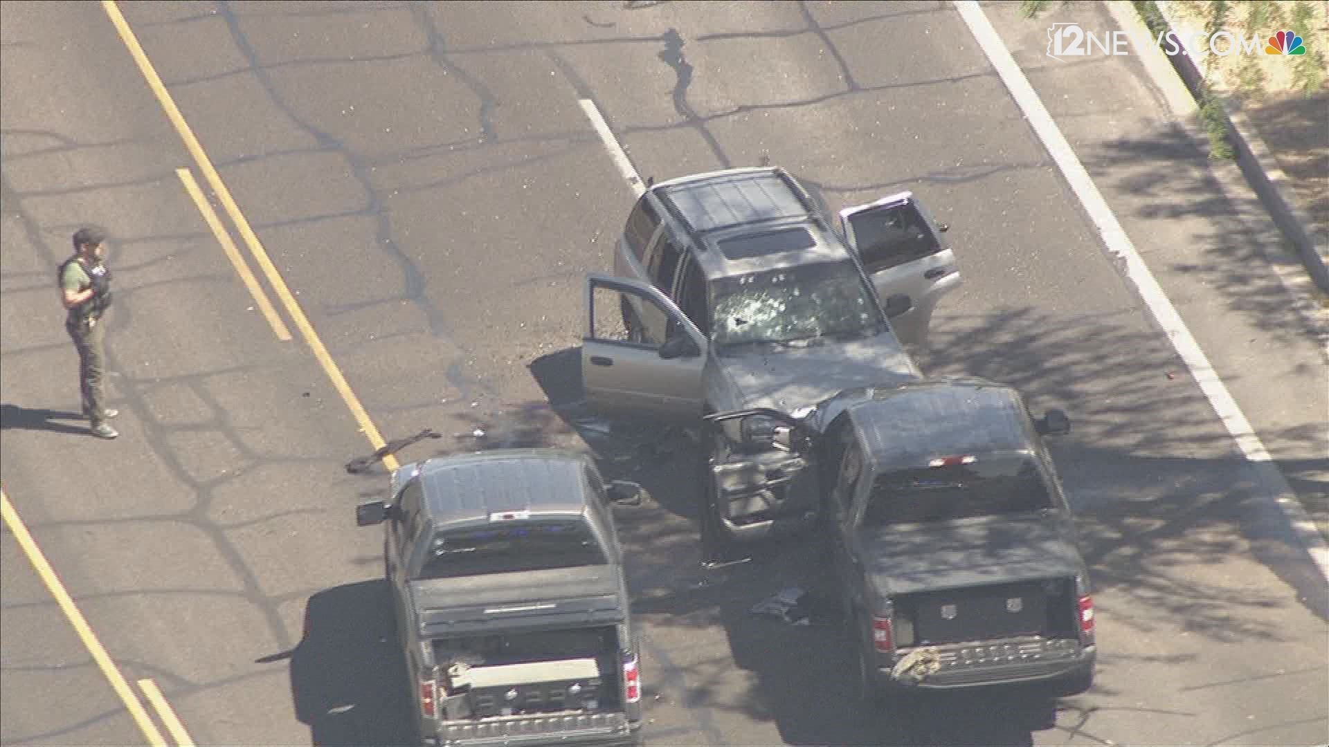 A police situation involving federal agents near 48th St. and Warner-Elliot Loop has at least one road blocked off. Aerial footage shows an SUV with multiple gunshots in the windshield, a truck that crashed into a wall and one person on a gurney.