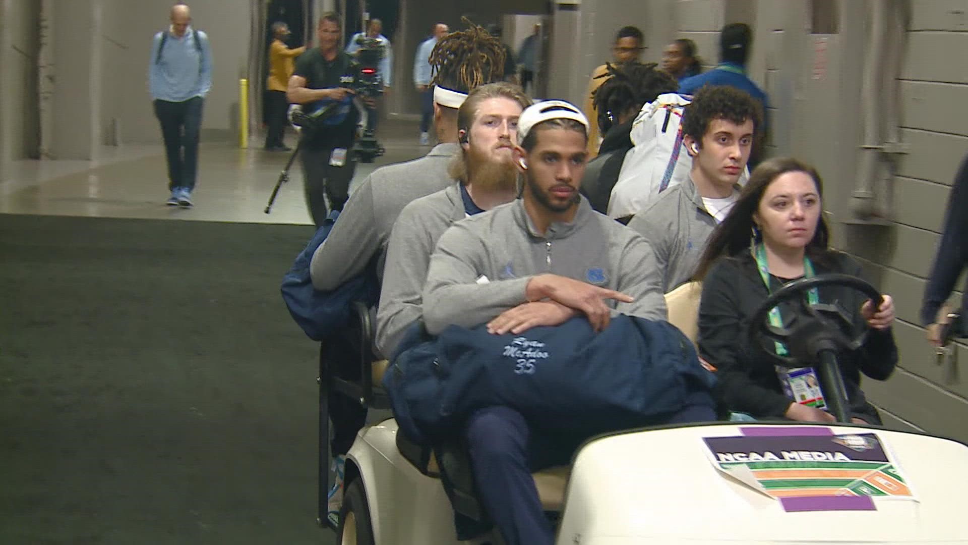 Who has time to walk when you have a national championship game ahead of you? Watch as they ride on a golf cart in style.