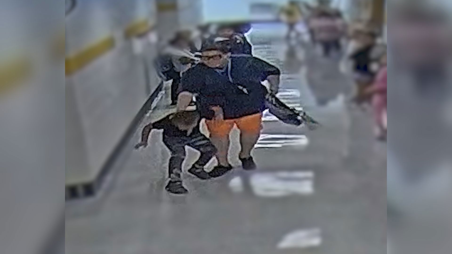 A Toledo Public Schools paraprofessional has been suspended without pay after surveillance video shows her allegedly restraining an 8-year-old student.